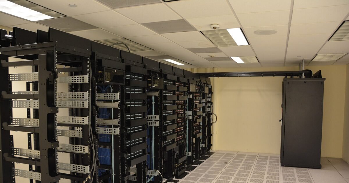 Rows of illuminated server racks in a modern data center