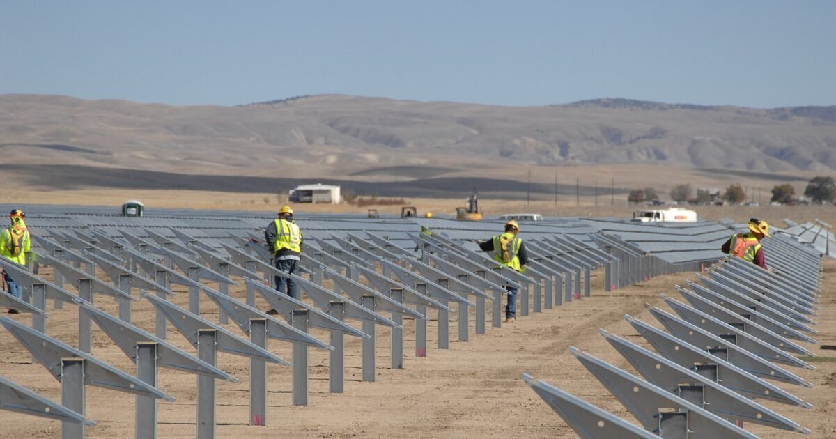 Landscape view of Topaz Solar Farm with rows of solar panels under maintenance