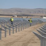 Landscape view of Topaz Solar Farm with rows of solar panels under maintenance