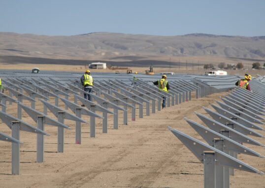 Landscape view of Topaz Solar Farm with rows of solar panels under maintenance