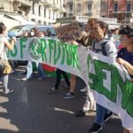 Young climate activists march with a Fridays for Future banner in Milan, Italy