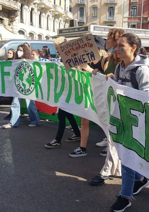 Young climate activists march with a Fridays for Future banner in Milan, Italy