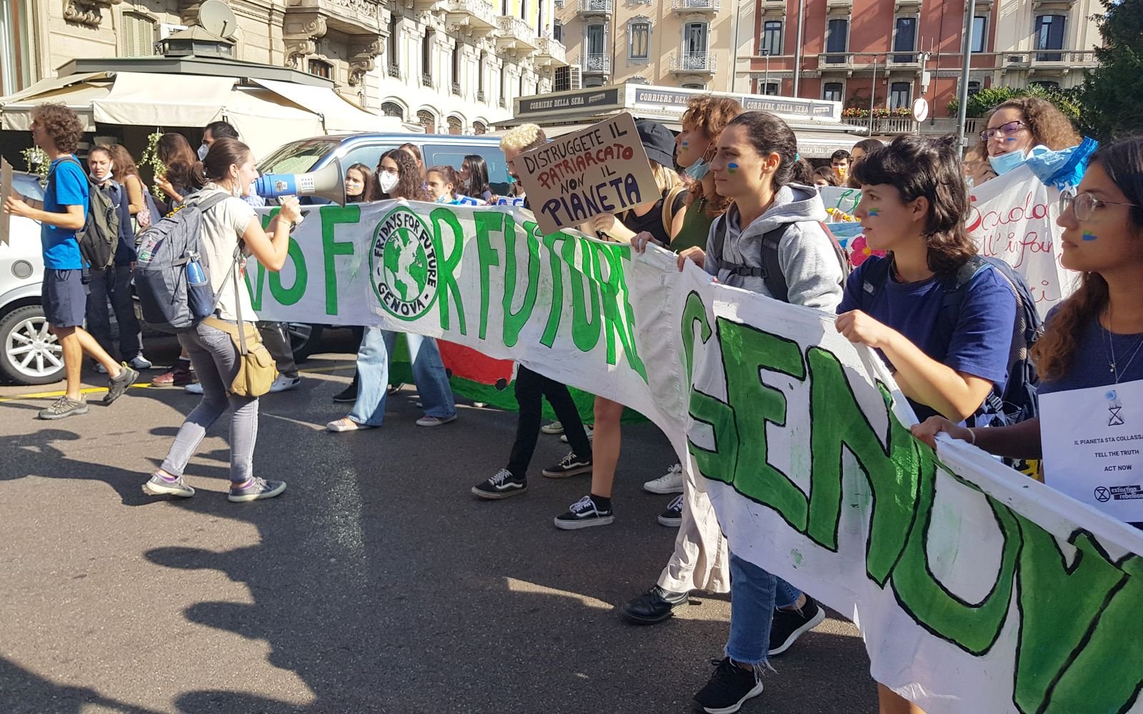 Young climate activists march with a Fridays for Future banner in Milan, Italy