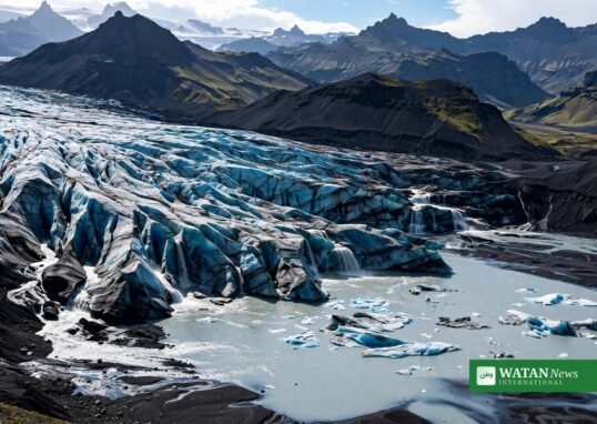 Aerial view of a retreating Icelandic glacier with braided meltwater rivers and floating icebergs