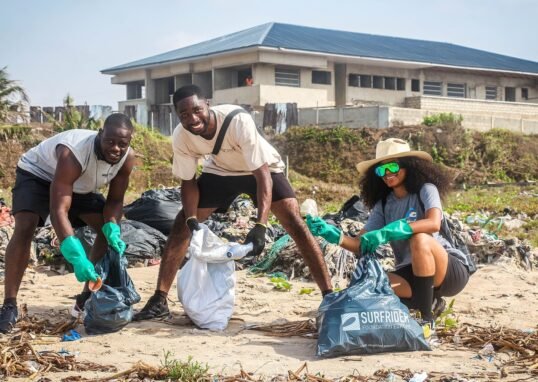 Volunteers collect plastic waste during a beach cleanup in Ghana