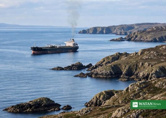 Oil tanker at sea near the rocky coast of Oman after a projectile strike