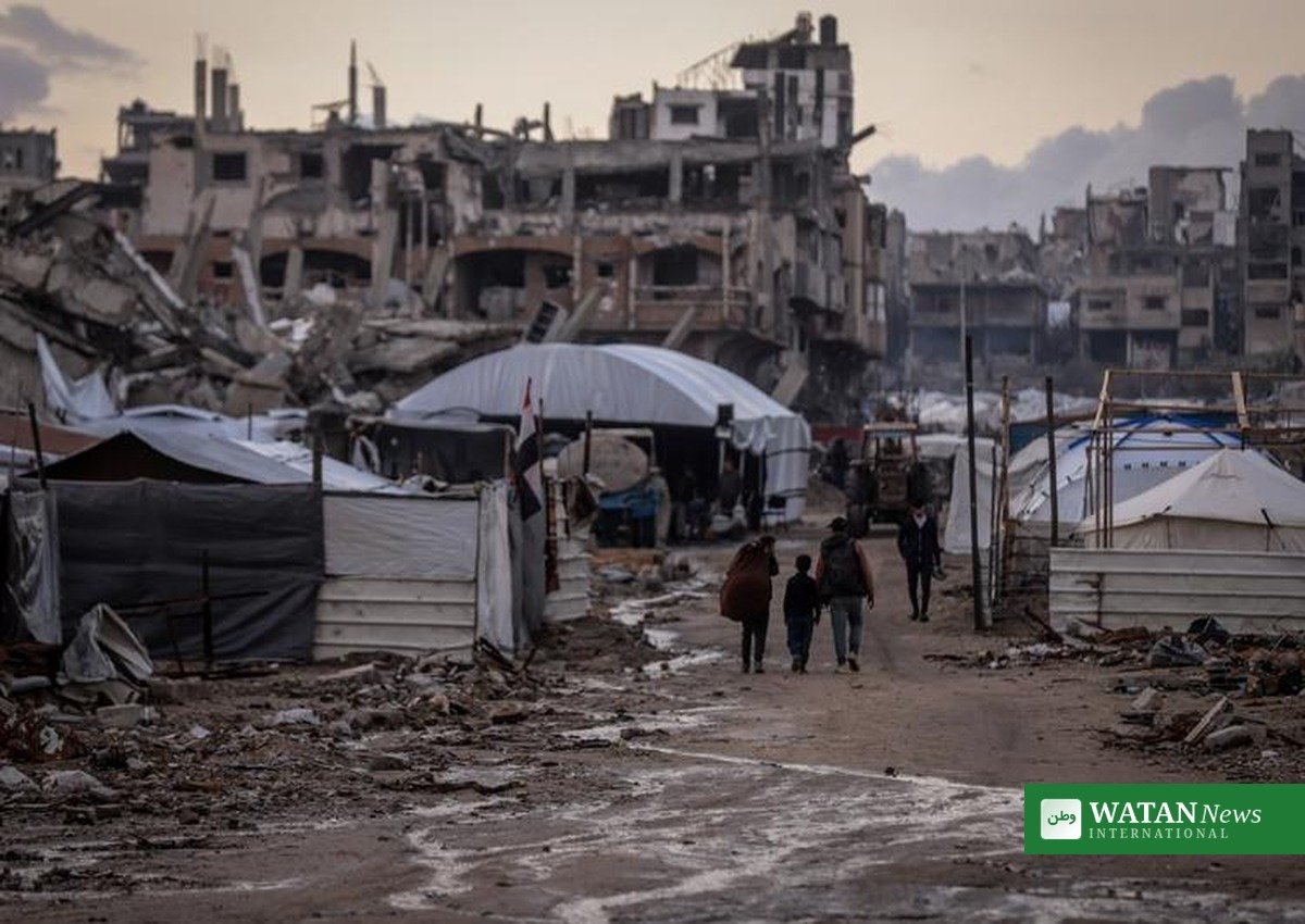 Displaced residents in a Gaza ceasefire tent camp among destroyed buildings