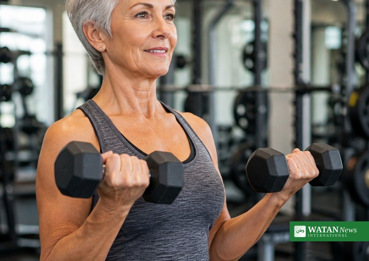 An older woman lifting dumbbells; strength training is central to fitness after 40