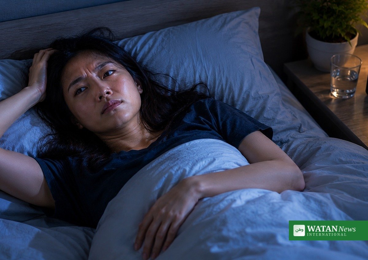 Woman lies awake at night struggling with insomnia, linked to higher stroke risk