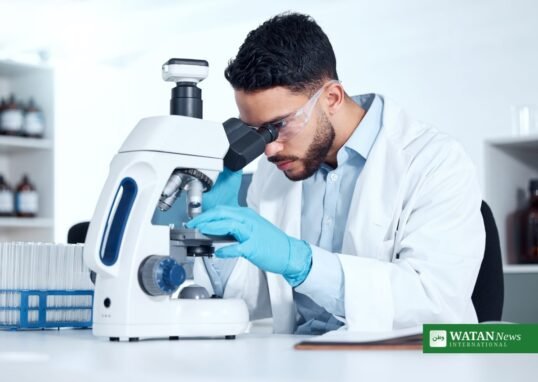 Scientist examining a sample under a microscope in a laboratory