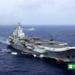 Chinese aircraft carrier Liaoning sailing at sea with escort warships