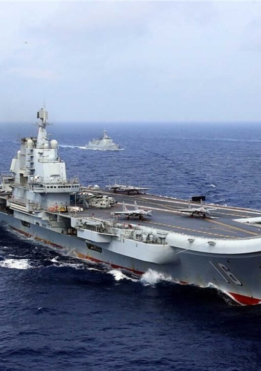 Chinese aircraft carrier Liaoning sailing at sea with escort warships