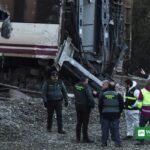 Investigators and Guardia Civil officers examine wrecked Renfe carriages at the Spanish rail crash site