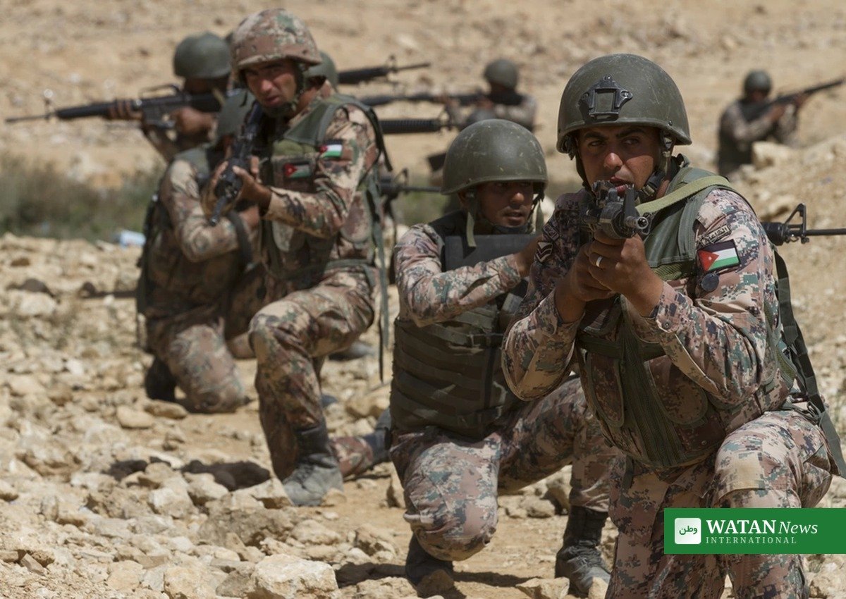 Jordanian soldiers on patrol in rocky desert terrain near the border