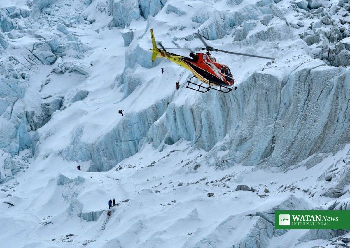 Rescue helicopter flying over a snow-covered Himalayan glacier