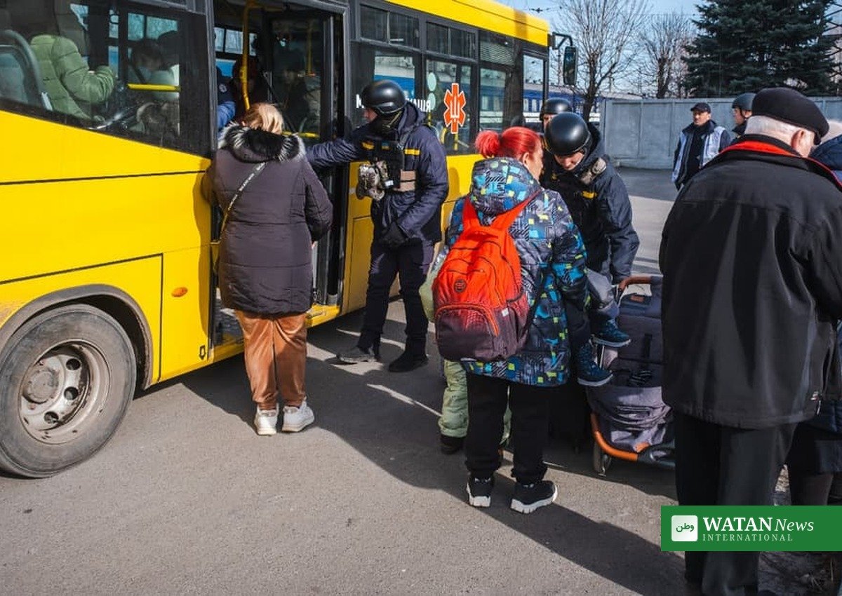 Civilians boarding a yellow evacuation bus in Ukraine