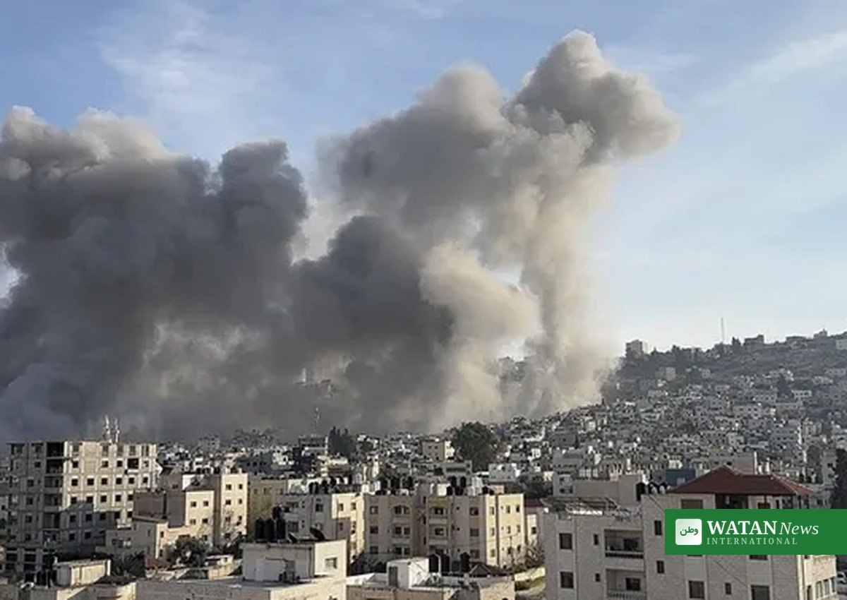 Gaza drone strikes aftermath: smoke plume rising over a city in the Gaza Strip