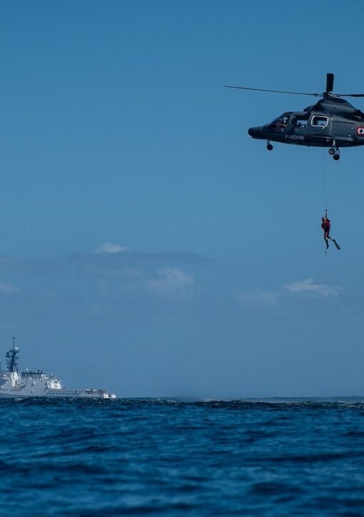 California smuggling boat rescue — U.S. Coast Guard cutter and search-and-rescue helicopter at sea