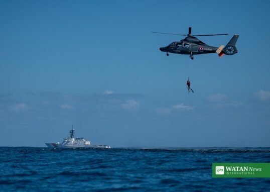 California smuggling boat rescue — U.S. Coast Guard cutter and search-and-rescue helicopter at sea
