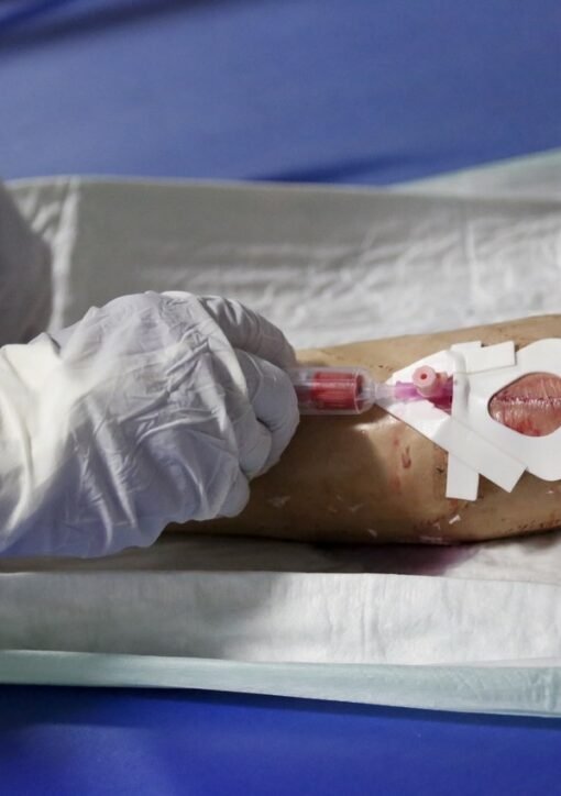 Kenya second Ebola death: health worker in full protective equipment takes a blood sample