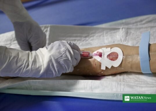 Kenya second Ebola death: health worker in full protective equipment takes a blood sample