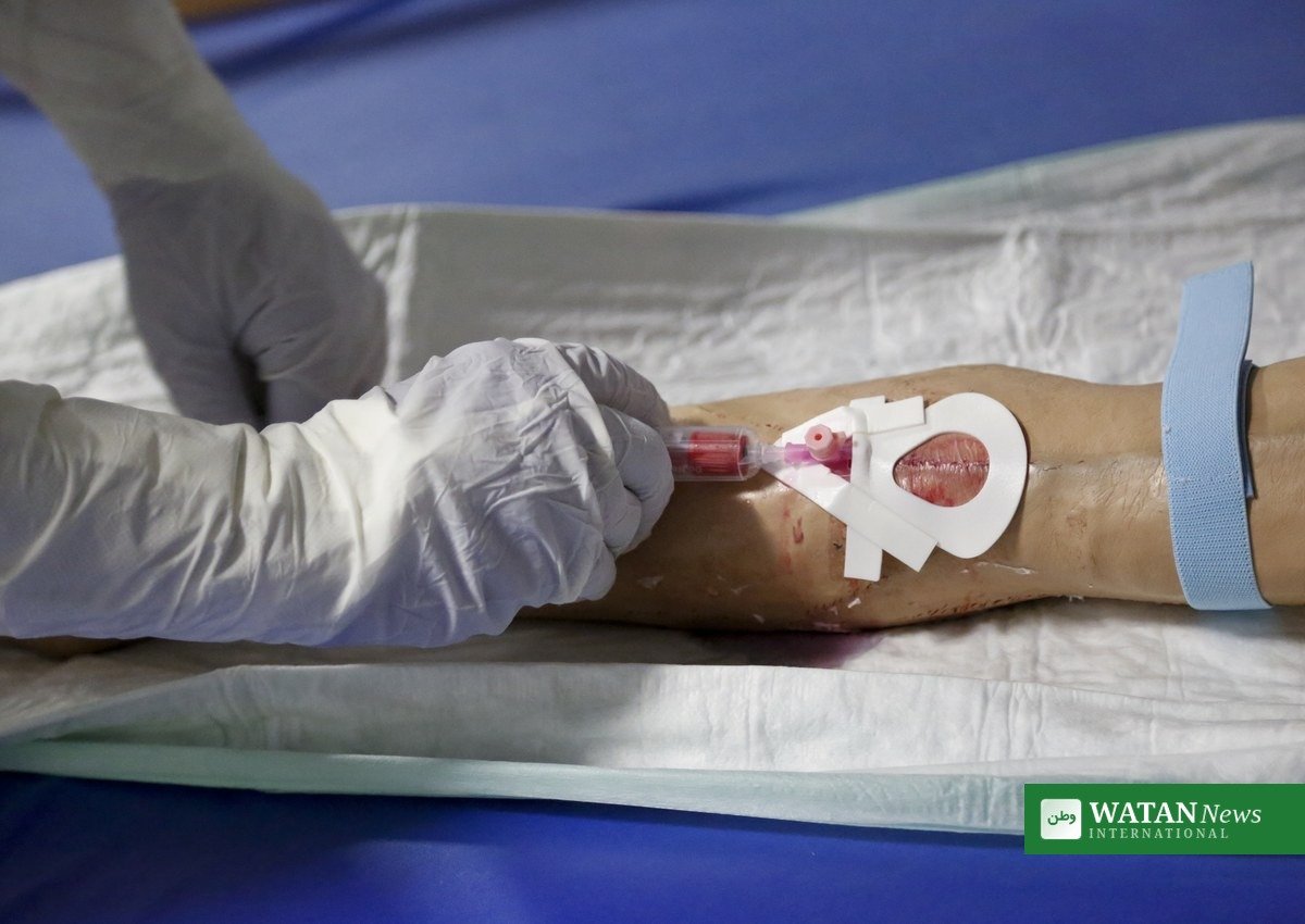 Kenya second Ebola death: health worker in full protective equipment takes a blood sample