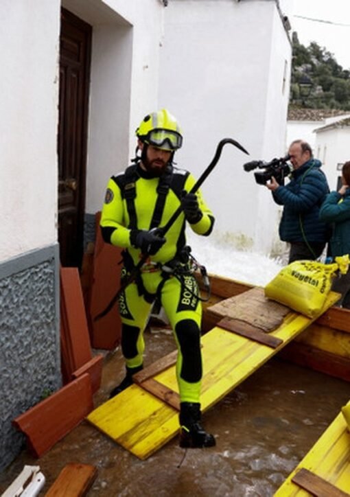 Firefighter places sandbags as Storm Adam floods rise in eastern Spain