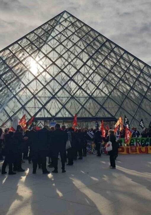 Student protesters staging the Louvre protest blockade in front of the glass pyramid, Paris