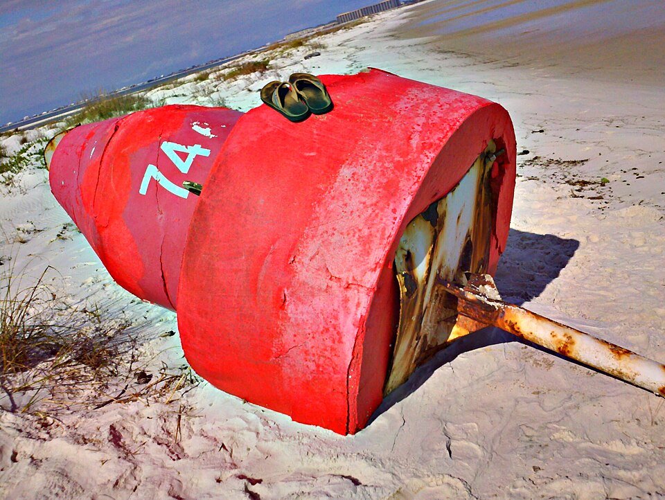 Ocean observation buoy on a beach beside the sea