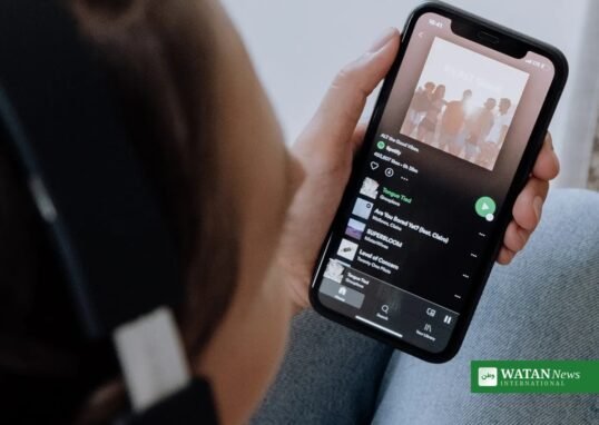 Spotify AI slop tracks removed: a listener browsing playlists on the Spotify app