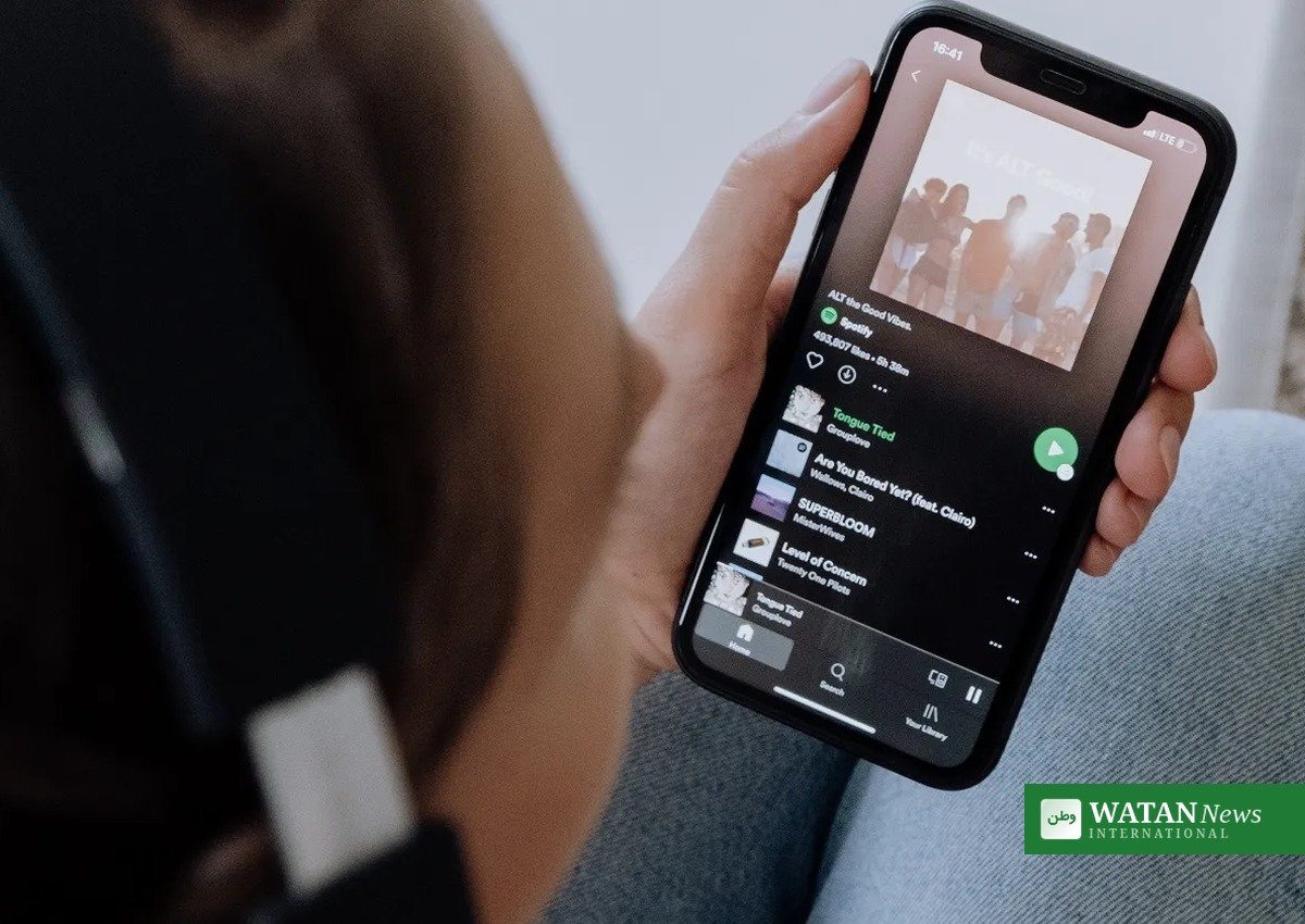 Spotify AI slop tracks removed: a listener browsing playlists on the Spotify app