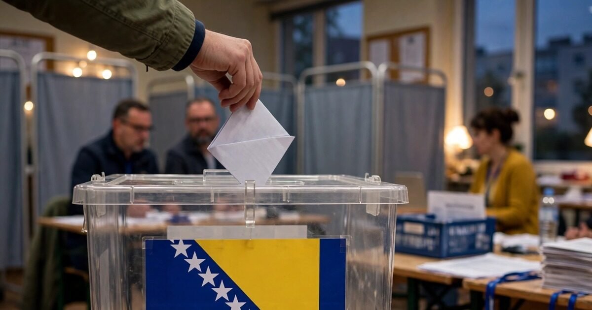 A voter casts a ballot into a box carrying the Bosnian flag as polls close in the Bosnia-Herzegovina election