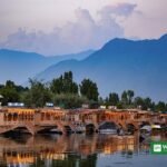 Houseboats on Dal Lake in Srinagar, Kashmir, with mountains behind