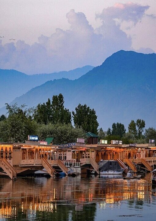 Houseboats on Dal Lake in Srinagar, Kashmir, with mountains behind