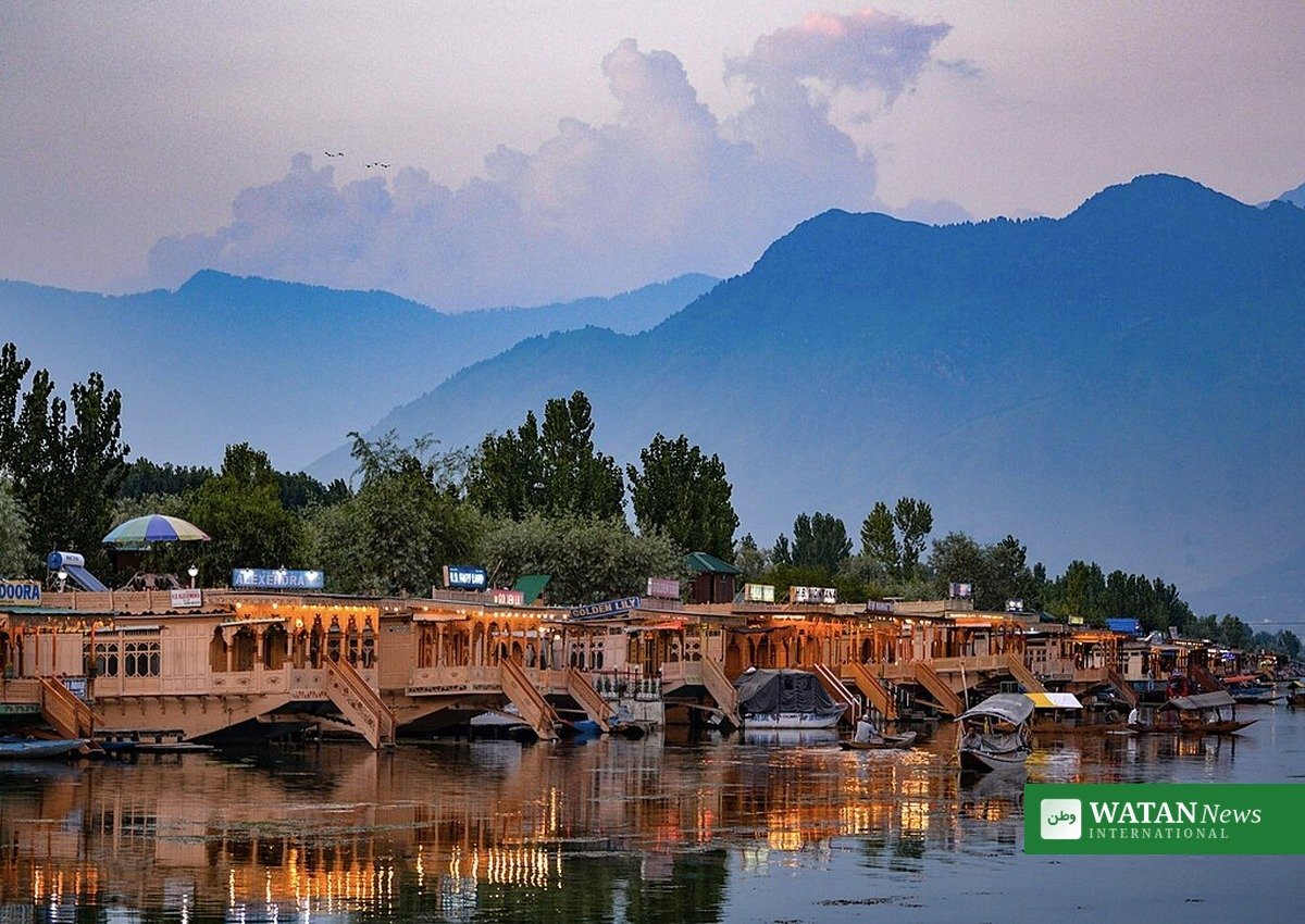 Houseboats on Dal Lake in Srinagar, Kashmir, with mountains behind