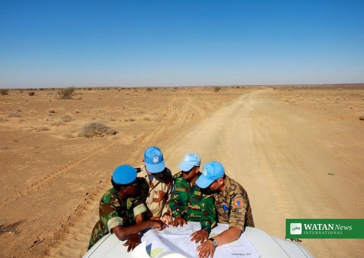 UN MINURSO peacekeepers in blue caps studying a map in the Western Sahara desert