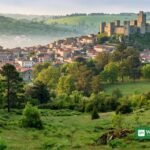 Guimarães castle and old town surrounded by green hills — the 2026 European Green Capital hosts the 2028 winners' announcement on 8 October