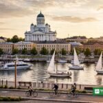 Helsinki harbor at golden hour with sailboats, the cathedral and cyclists on the waterfront promenade — Helsinki topped the 2026 GDS-Index