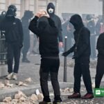 Masked demonstrators with stones amid tear gas during the Paris cost-of-living protest on 31 October 2026