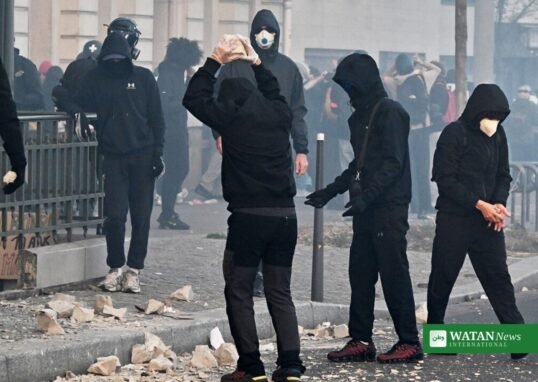 Masked demonstrators with stones amid tear gas during the Paris cost-of-living protest on 31 October 2026