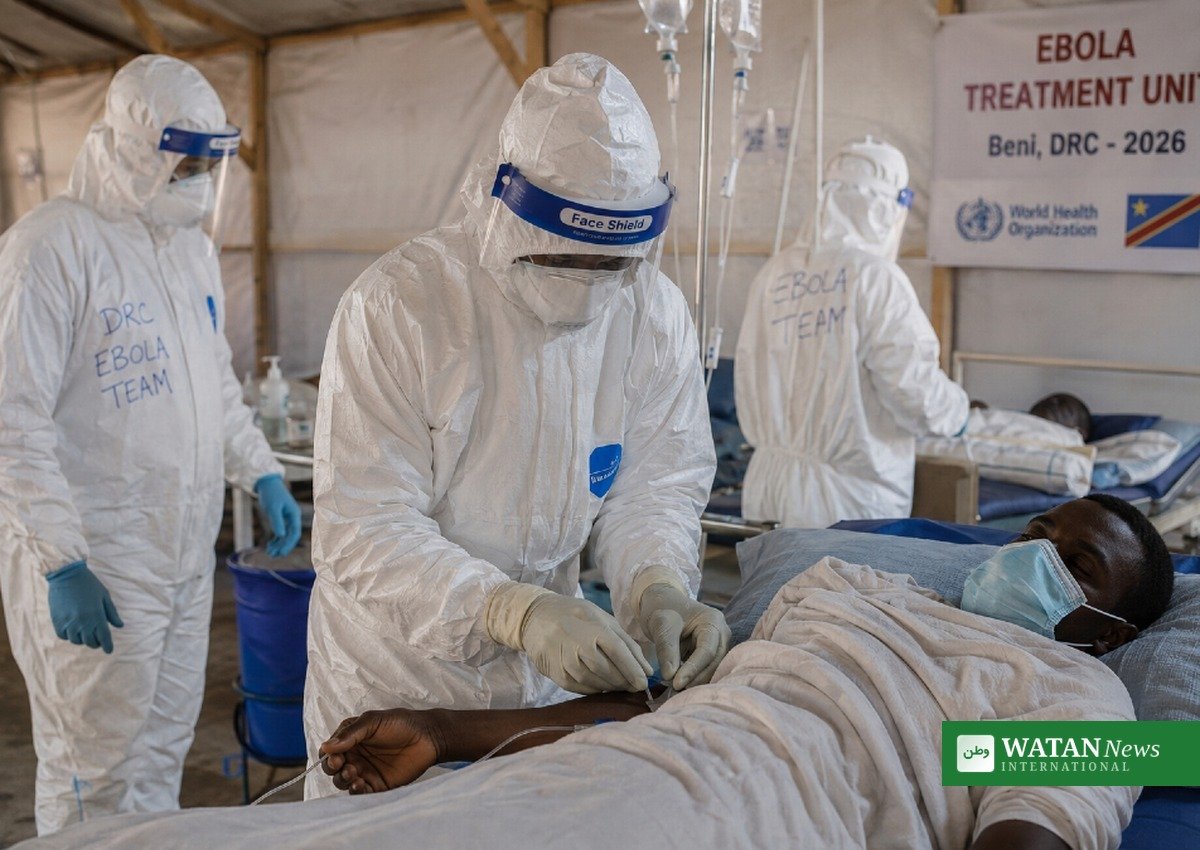 Health workers treating a patient inside an Ebola treatment unit in Beni, DR Congo