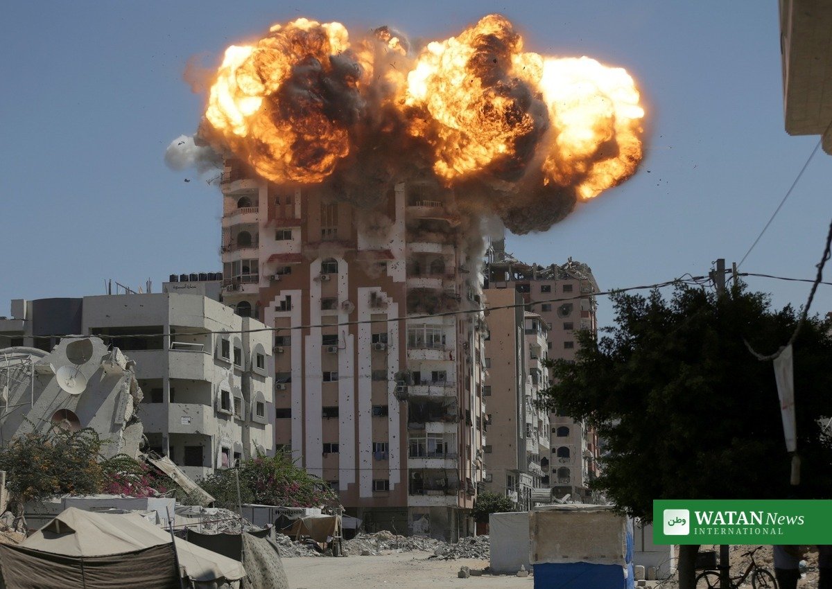 Smoke rises over a Gaza City building during an Israeli airstrike targeting Ali al-Amoudi