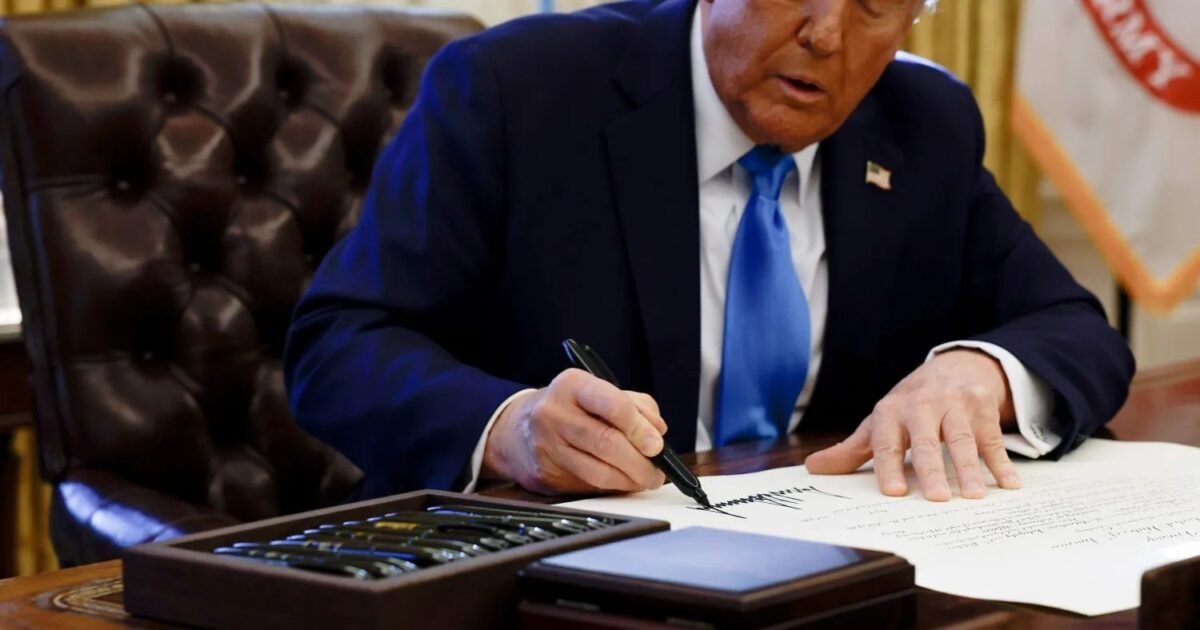Donald Trump signing an executive order as the Trump human rights funds are redirected to far-right causes