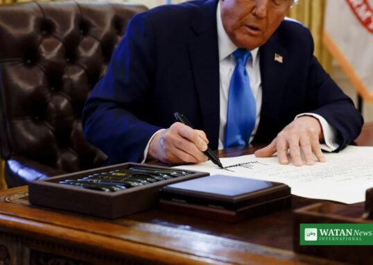 Donald Trump signing an executive order as the Trump human rights funds are redirected to far-right causes