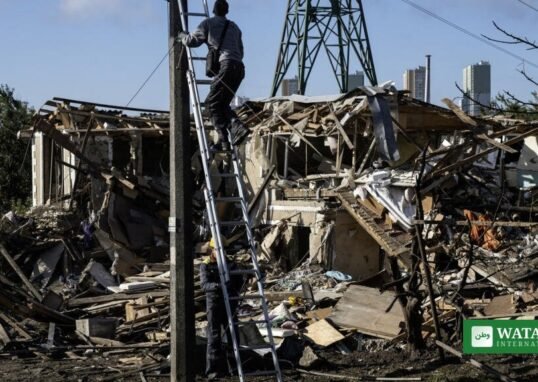 Ukraine energy grid attack: rescue worker climbs a ladder amid rubble after Russian strikes