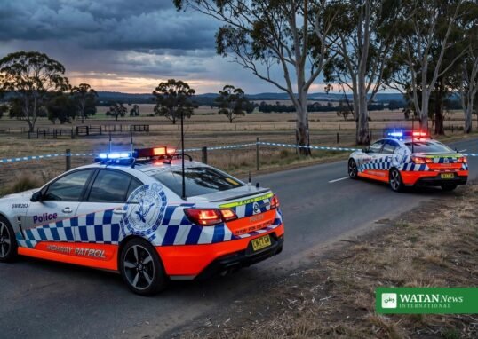 NSW police shooting scene: highway patrol cars with flashing lights at a rural road near Yass