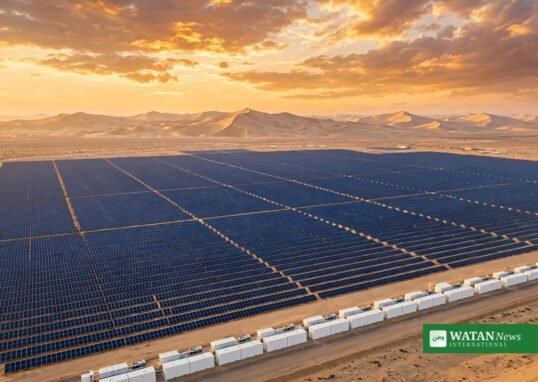 Pugal solar plus storage – aerial view of desert solar farm with battery storage containers at sunset