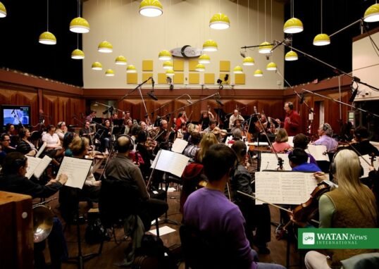 Orchestra musicians recording a film score in a studio