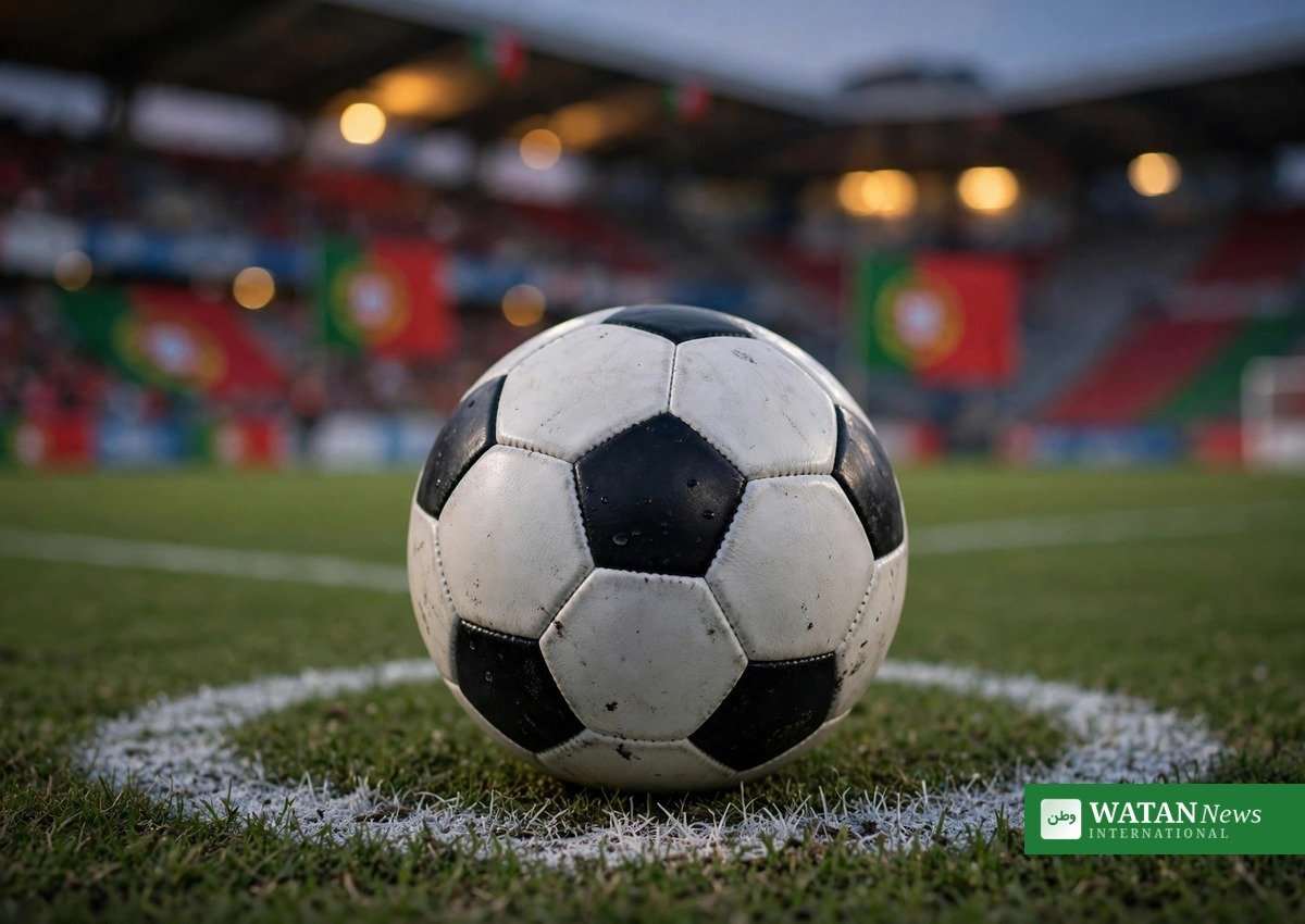 Football on the penalty spot with Portugal flags in a stadium at dusk, illustrating the Ronaldo 30-day suspension story
