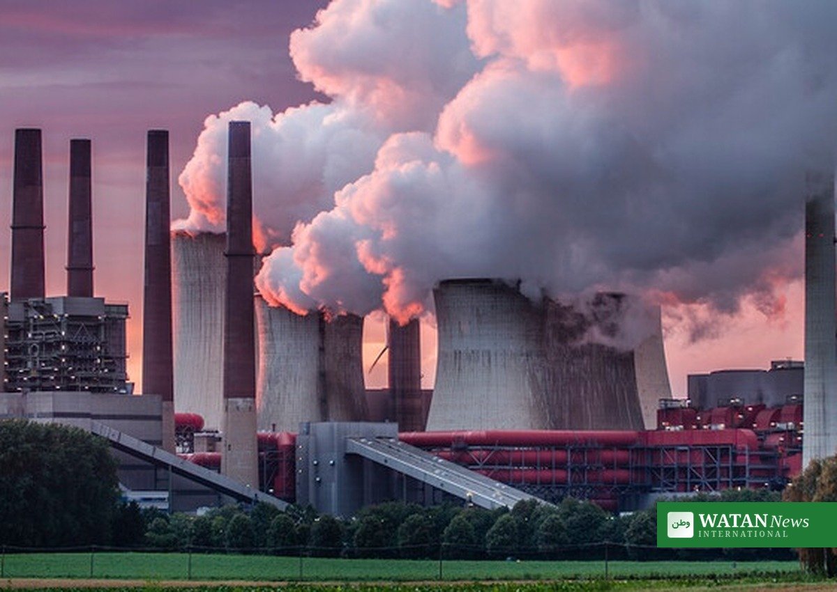 Coal-fired power plant with cooling towers under a hazy sky, illustrating the EPA's proposed repeal of power plant emissions standards